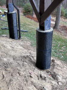 Foundation stabilization columns installed to support structural integrity, showcasing moisture management techniques in foundation repair.