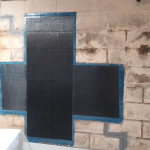 Carbon fiber repair system applied to foundation wall, showcasing structural reinforcement for crack stabilization.